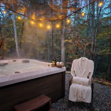 Private couples spa setting with hot tub and forest view