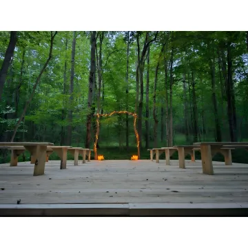 Couple planning an intimate forest wedding with venue host
