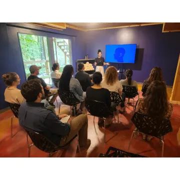 Adults planning an art retreat in a forest lodge