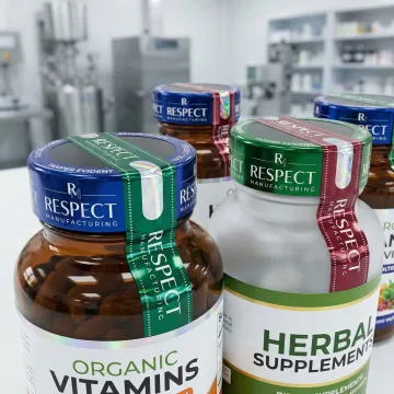 Close-up of professionally banded supplement bottles showing custom branded tamper-evident seals