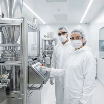 Technicians working in modern capsule manufacturing facility