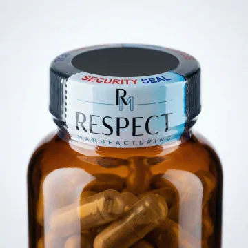 Close-up of branded tamper-evident band on dietary supplement bottle showing professional finish