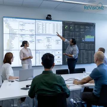 Industrial asset management team reviewing digital dashboards
