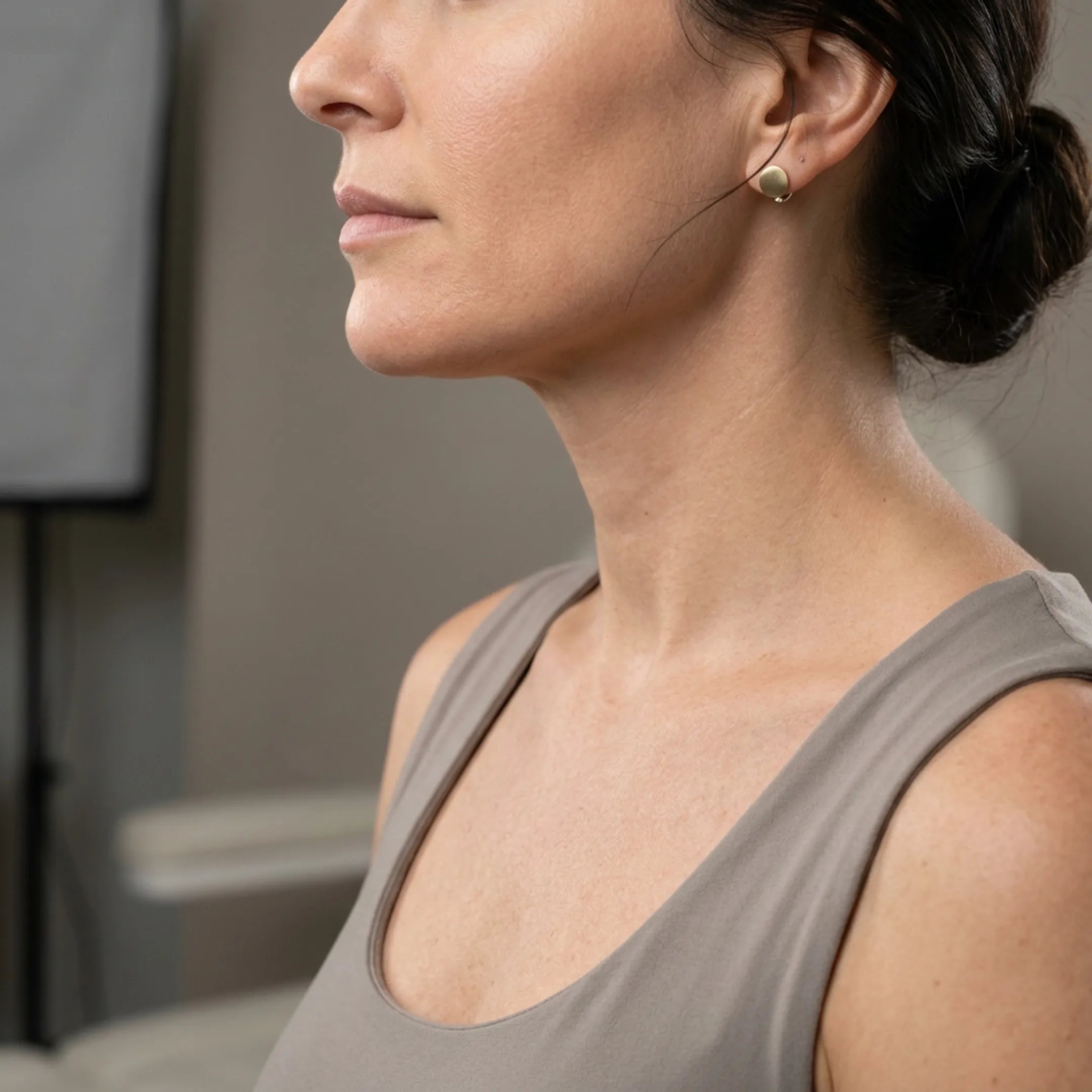 Close-up of a client showing refined jawline and smooth neck contour after treatment