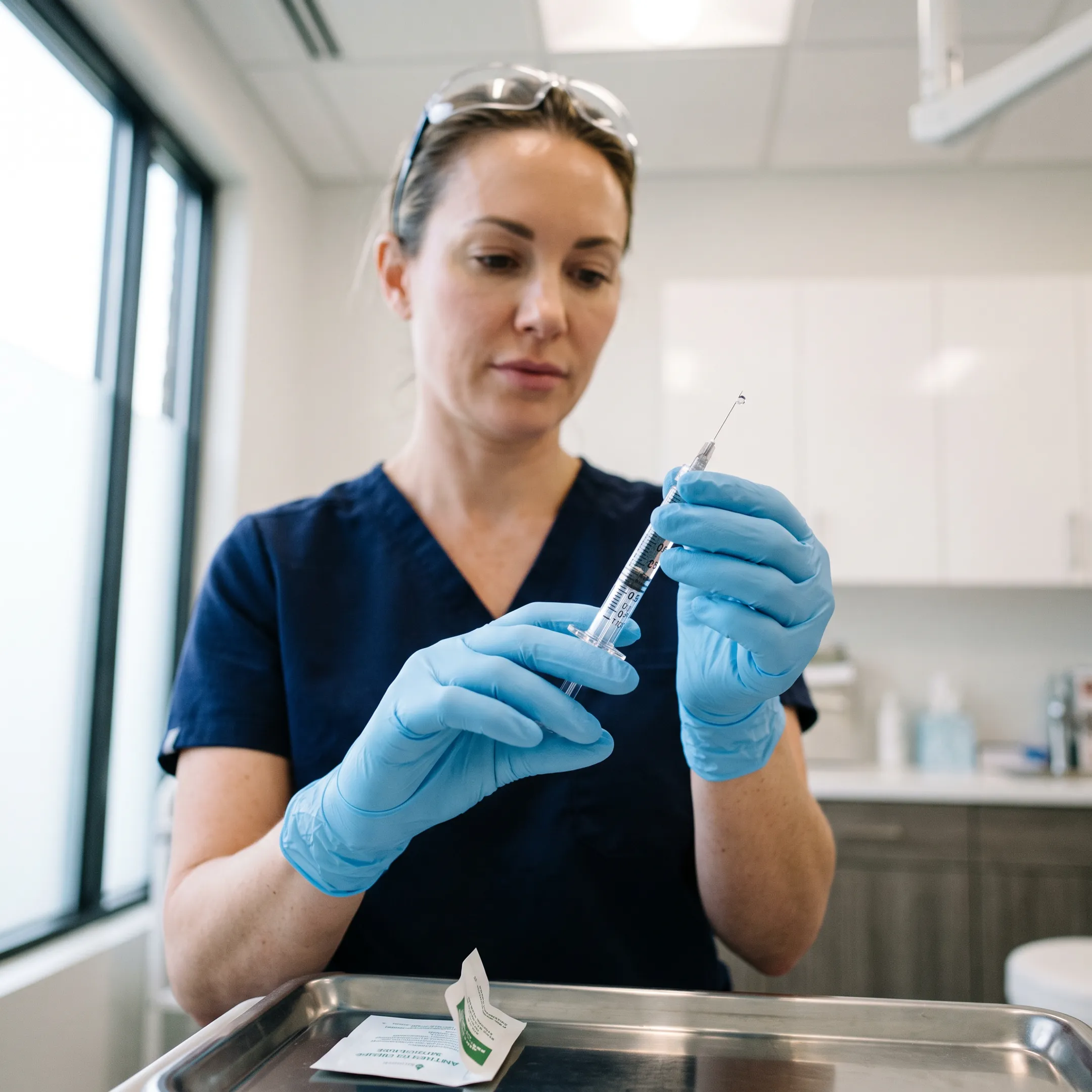 Aesthetic nurse injector preparing lip filler treatment in a modern medical spa