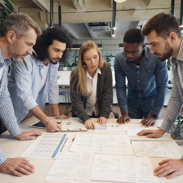Business operations consultants reviewing assessment strategy