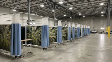 Portable medical privacy screens deployed in emergency shelter triage area