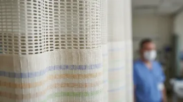 Fabric hospital curtain surface showing porous textile material and contamination risk