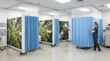 Rolascreen Portable Elite and Wall-Mounted Elite privacy screens deployed in healthcare setting