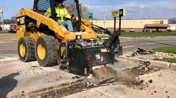Rolling Wedge RW103-B attachment mounted on skidsteer removing asphalt