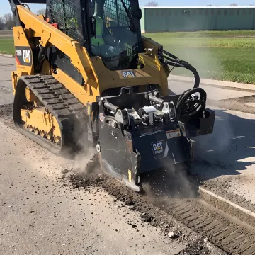 Milling attachment cutting a smooth asphalt surface