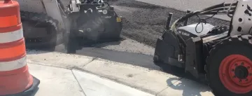 Asphalt milling machine removing a road surface