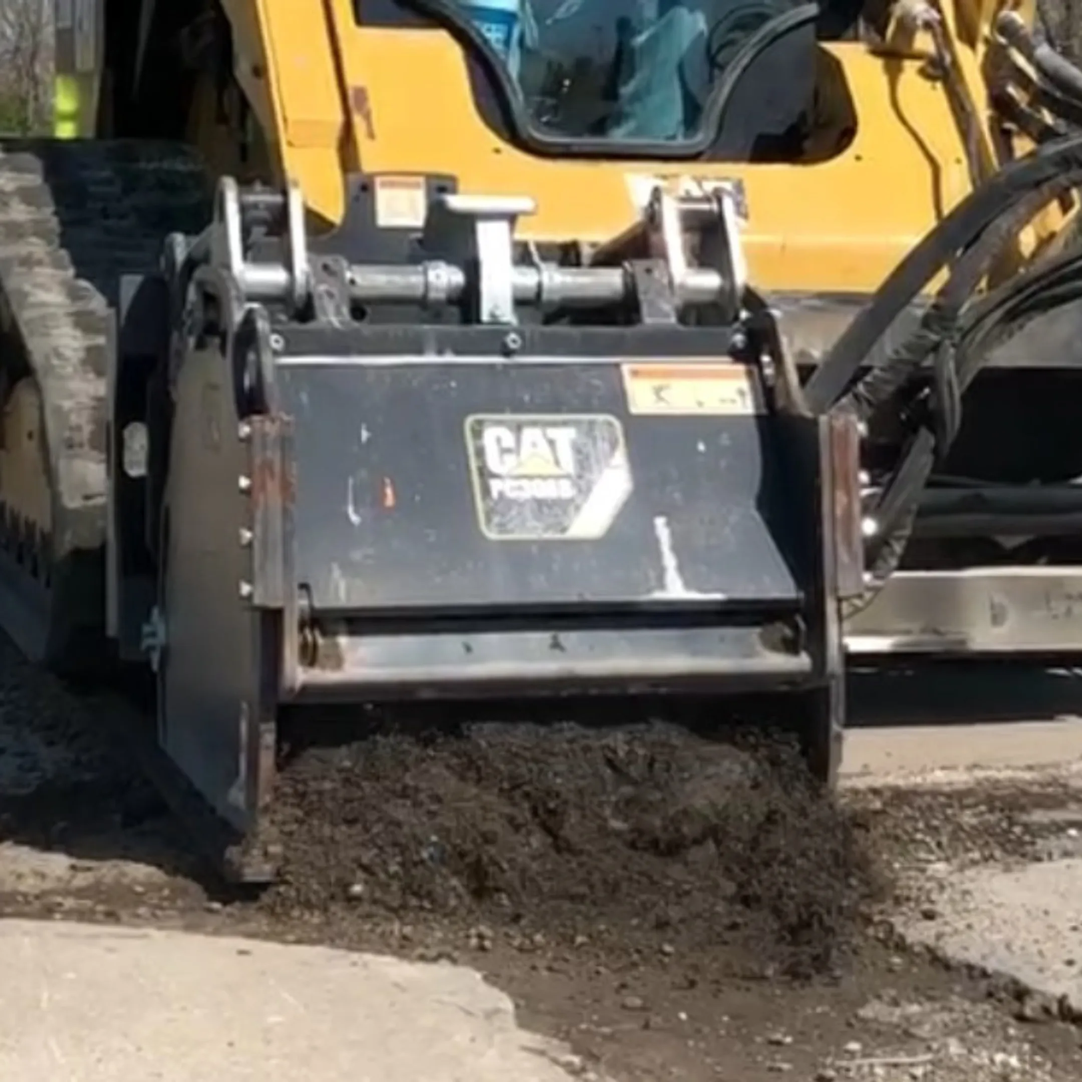 Milling attachment cutting a smooth asphalt surface