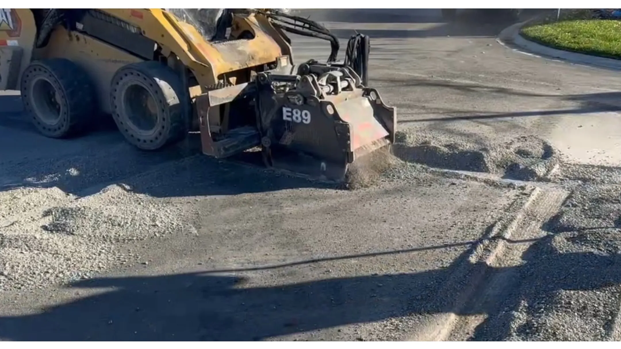 Rolling Wedge RW103-B milling attachment removing asphalt driveway surface