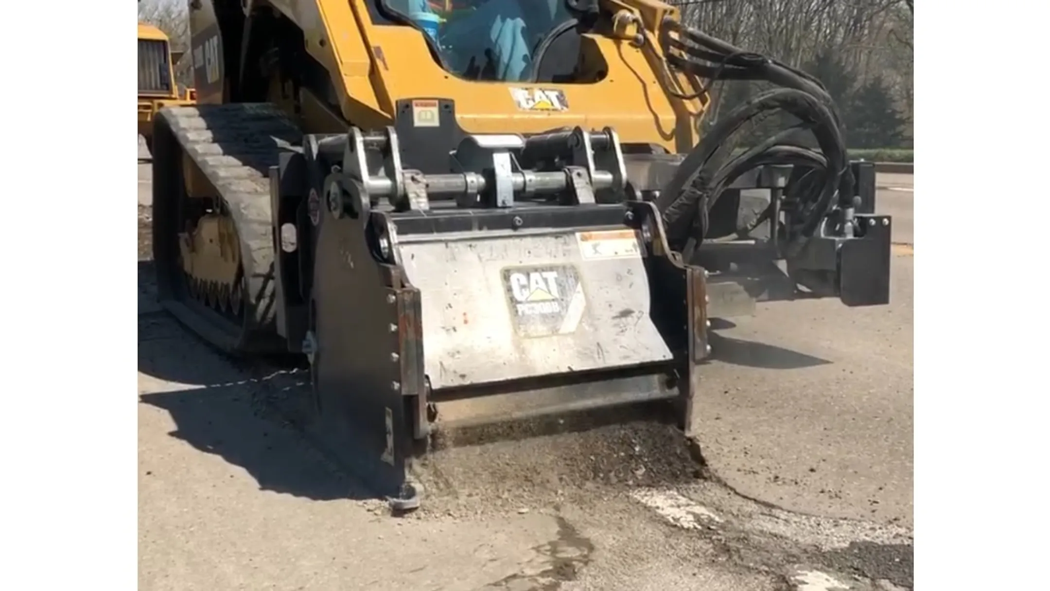 Concrete milling machine grinding damaged highway pavement surface
