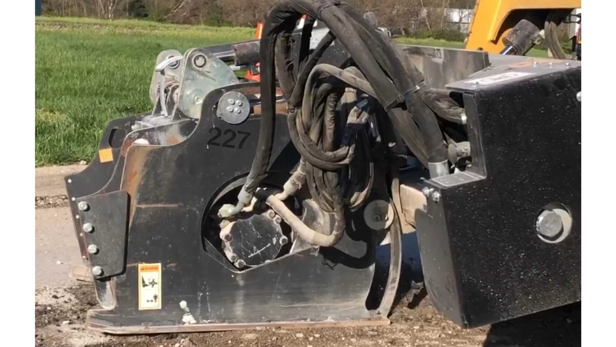 Rolling Wedge RW103-B attachment mounted on skidsteer removing asphalt