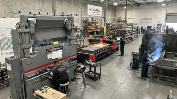 Precision metal fabrication shop floor with laser cutting and welding equipment