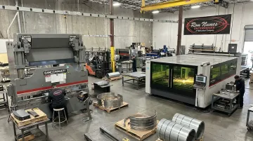 Sheet metal fabrication shop floor with press brake and laser cutting machinery