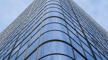 Curved aluminum curtain wall framing on modern commercial building facade