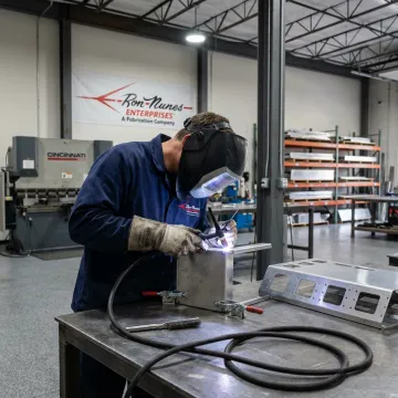 Technician welding an aluminum assembly