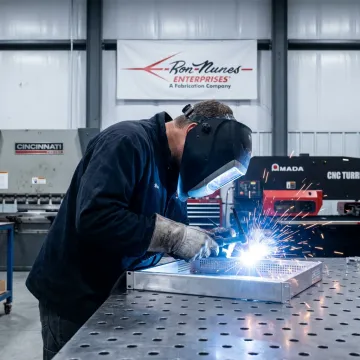 Welder fabricating precision metal assembly