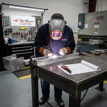 Metal fabrication team welding custom parts