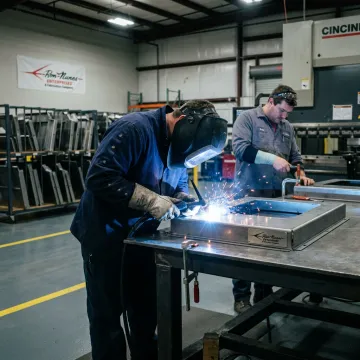 Fabricators welding a steel tank assembly