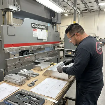 Technician inspecting fabricated sheet metal parts