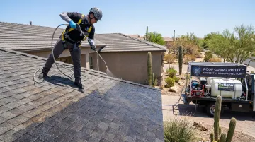 Roof Guard Pro technician applying GoNano Shingle Saver treatment on residential roof