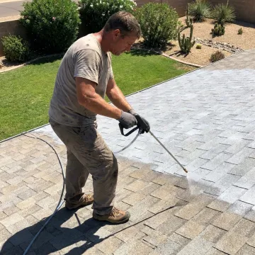 Technician applying UV-protective coating to a shingle roof