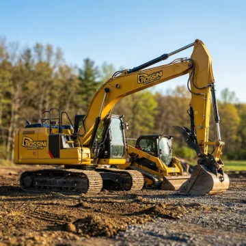 Heavy excavator and skid steer on Thompson NY construction site