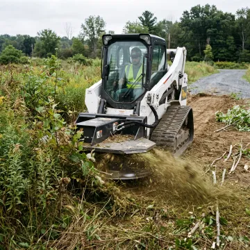 Brush cutter clearing an overgrown lot