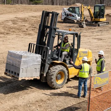 Forklift moving materials on a construction site