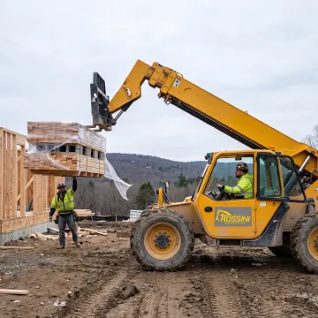 Telehandler lifting palletized materials at a jobsite