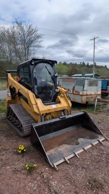 Skid Steer with Grapple Attachment