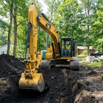 Well-maintained excavator performing foundation work at Sullivan County construction site
