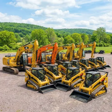 Heavy construction equipment fleet including excavators and loaders at Sullivan County facility