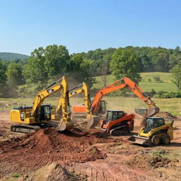 Heavy construction excavator and skid steer equipment on job site in Narrowsburg NY
