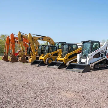 Heavy construction equipment rental yard with excavators and skid steers in Plymouth, WI