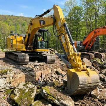 Heavy excavator breaking ground on a Sullivan County construction site
