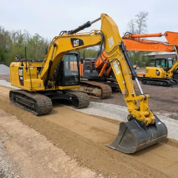Excavator operator performing precise grading work on construction site