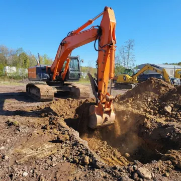 Heavy excavator at construction site preparing foundation