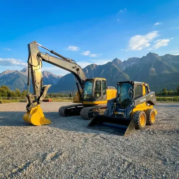 Heavy construction equipment including excavators and skid steers ready for rental