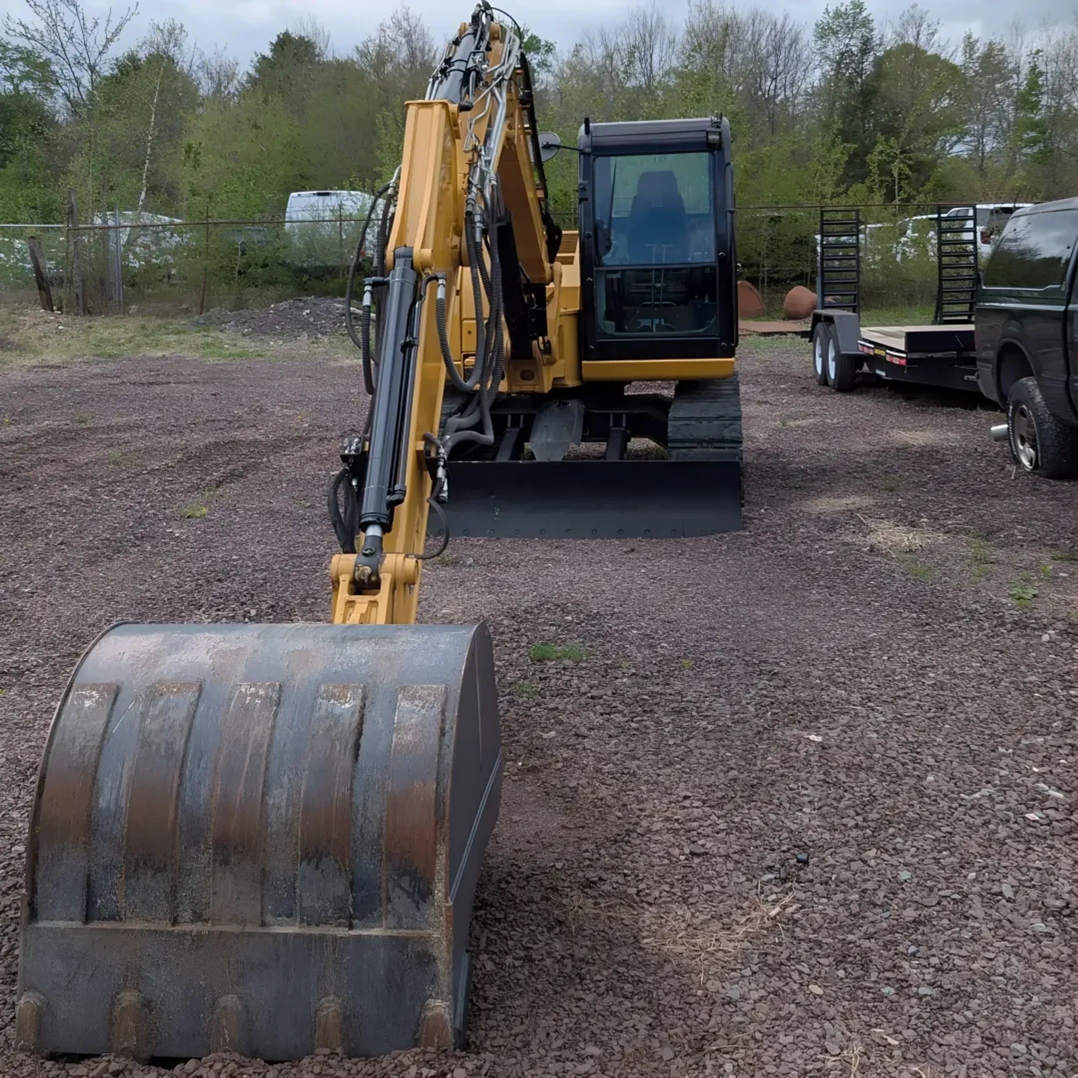 Heavy construction equipment including earthmoving machines and skid steers at a rental yard in Livingston Manor, Sullivan County