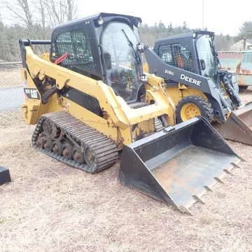 Earthmoving machine and skid steer ready for rental delivery