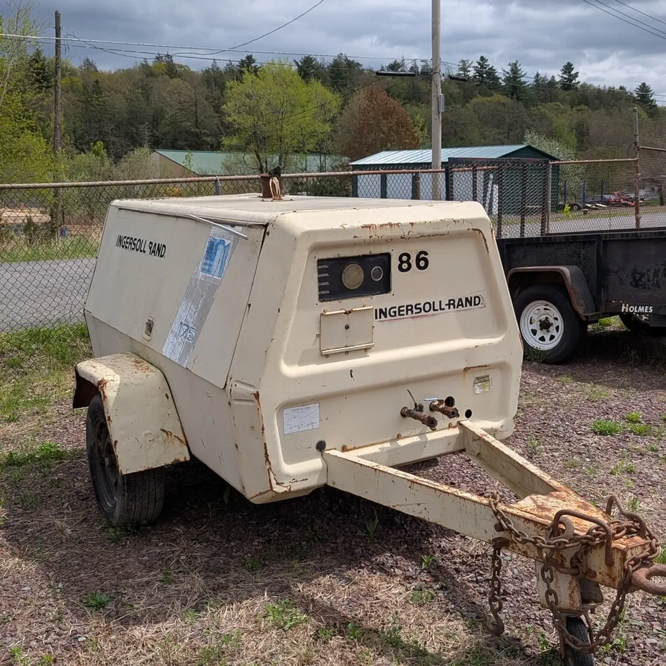 Modern earthmoving machine and skid steer equipment ready for rental at Rossini Equipment Corp yard