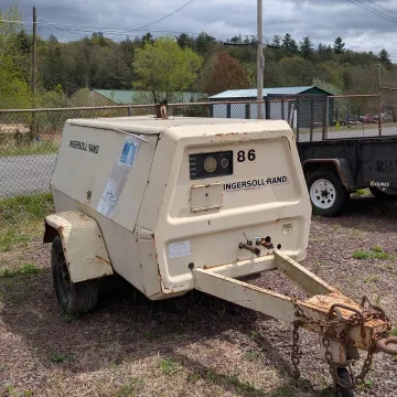 Modern earthmoving machine and skid steer equipment ready for rental at Rossini Equipment Corp yard
