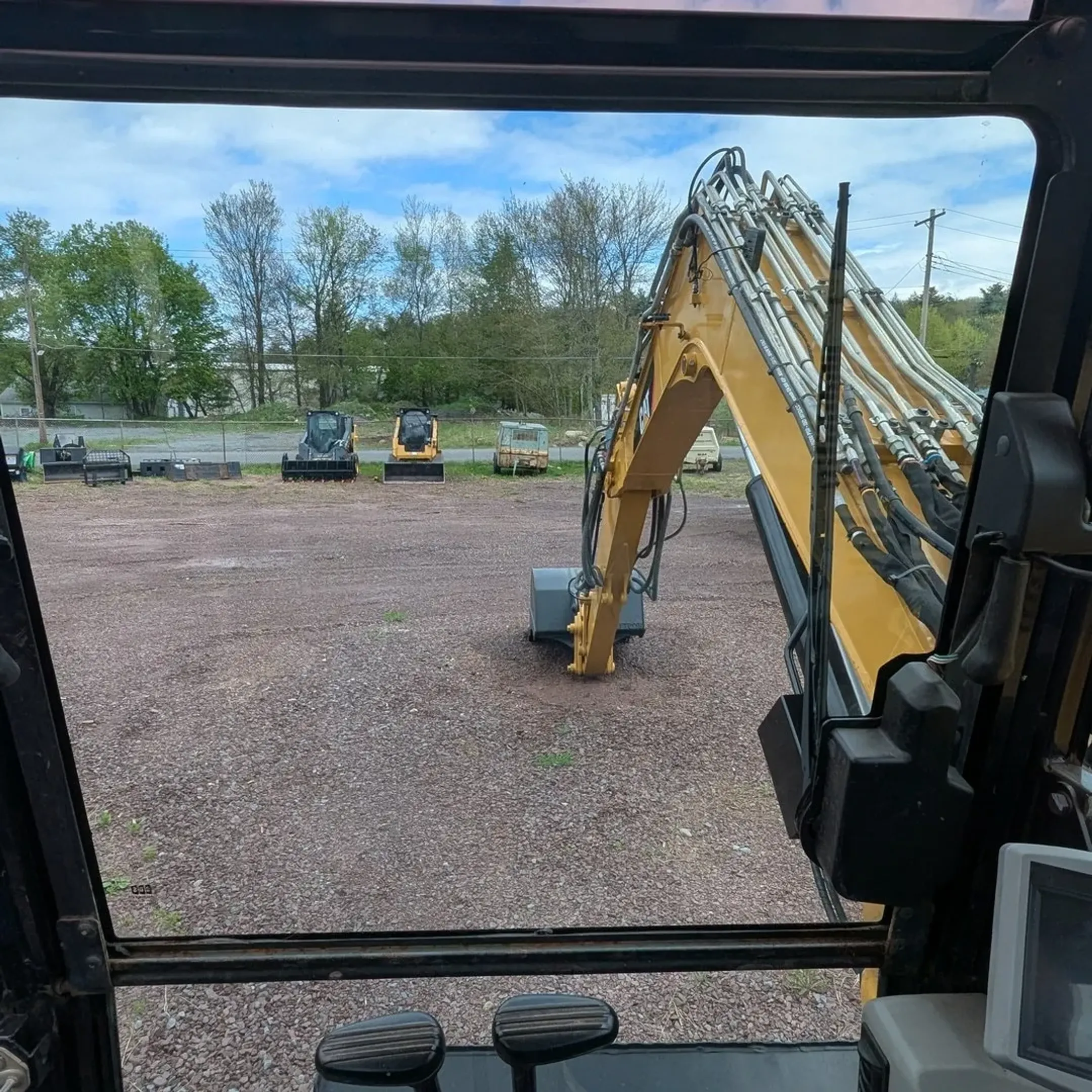 Fleet of heavy construction equipment including earthmoving machines and loaders at Rossini Equipment yard