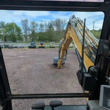 Fleet of heavy construction equipment including earthmoving machines and loaders at Rossini Equipment yard