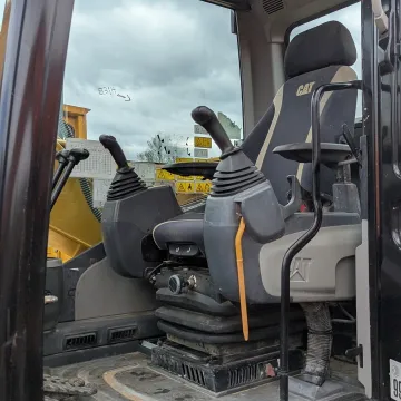 Construction equipment rental delivery truck transporting earthmoving machine to jobsite